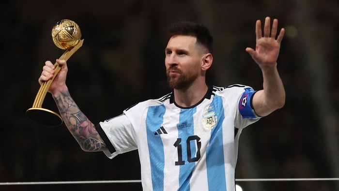 Soccer Football - FIFA World Cup Qatar 2022 - Final - Argentina v France - Lusail Stadium, Lusail, Qatar - December 18, 2022 Argentinas Lionel Messi celebrates winning the Golden Ball award with the trophy REUTERS/Carl Recine