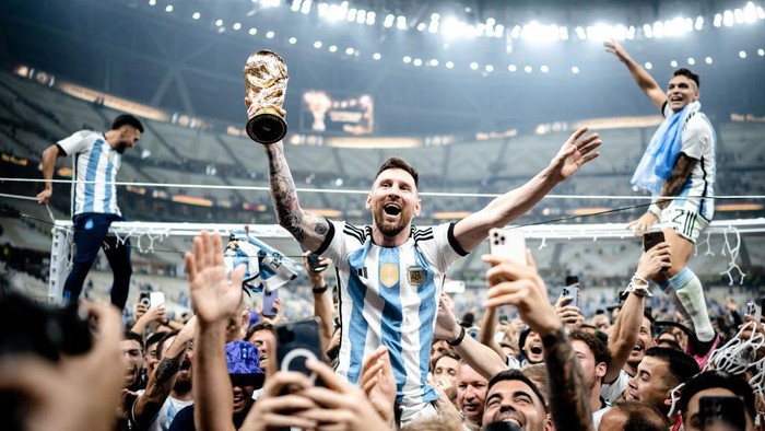 LUSAIL CITY, QATAR - DECEMBER 18: Lionel Messi of Argentina celebrates victory with the trophy after the FIFA World Cup Qatar 2022 Final match between Argentina and France at Lusail Stadium on December 18, 2022 in Lusail City, Qatar. (Photo by Marvin Ibo Guengoer - GES Sportfoto/Getty Images)