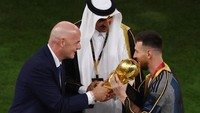 Presiden FIFA Gianni Infantino menyerahkan trofi Piala Dunia kepada Lionel Messi dari Argentina dan disaksikan oleh Emir Qatar Sheikh Tamim bin Hamad Al Thani. Foto: Reuters/Paul Childs