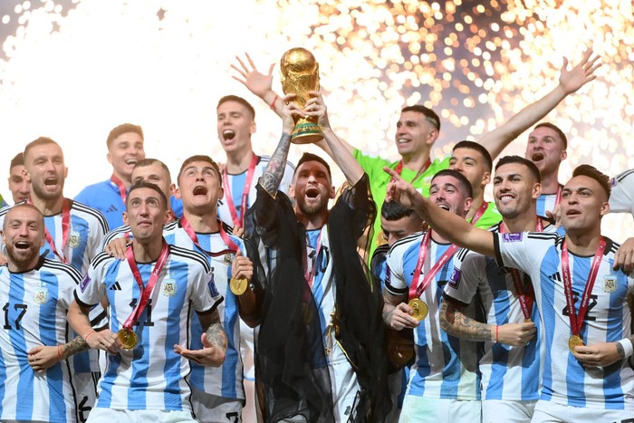 LUSAIL CITY, QATAR - DECEMBER 18: Lionel Messi of Argentina lifts the FIFA World Cup Qatar 2022 Winners Trophy during the FIFA World Cup Qatar 2022 Final match between Argentina and France at Lusail Stadium on December 18, 2022 in Lusail City, Qatar. (Photo by Dan Mullan/Getty Images)