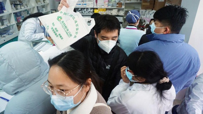 COVID-19 masih merajalela di negara China. Warga rela antre berdesakan untuk membeli reagen antigen COVID-19 di sebuah apotek.