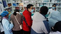 Warga mengantre di sebuah apotek di Hangzhou, provinsi Zhejiang, China, Senin (19/12/2022).