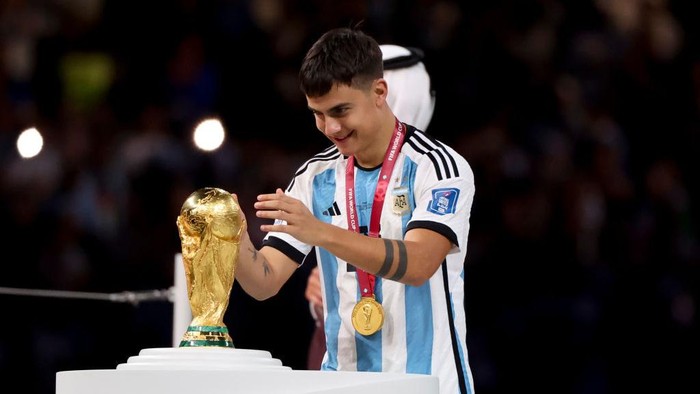 LUSAIL CITY, QATAR - DECEMBER 18: Paulo Dybala of Argentina touching the World Cup during the trophy ceremony following the FIFA World Cup Qatar 2022 Final match between Argentina and France at Lusail Stadium on December 18, 2022 in Lusail City, Qatar. (Photo by Jean Catuffe/Getty Images)