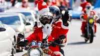 Pengendara melengkapi dirinya dengan pakaian Sinterklas dan menghiasi motornya dengan hewan rusa.  