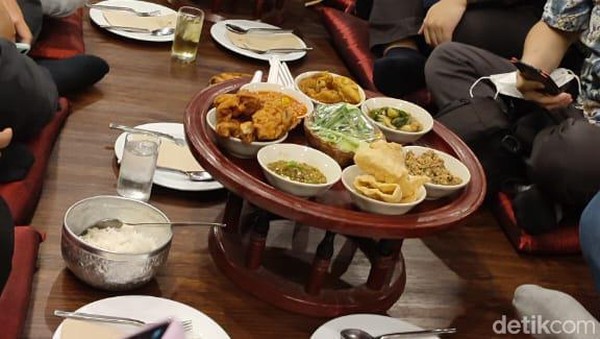 Khantoke Thailand disajikan di atas piring rotan lebar dan diletakkan di atas meja kecil yang cukup tinggi. Semua makanan ditumpuk di atasnya.