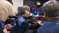 Chiang Yi-Shu watches the screen during the competition at Hungkuang University in Taichung, Taiwan on Saturday, Dec. 17, 2022.Chiang is one of the League of Legends players on Hungkung Evergreen Gamings team, established this summer. The team, whose members range from 62 to 69 years old, was founded by Huang Jianji, the director of the department of Multimedia Game development and application of Hungkuang University. They competed in their first-ever video game tournament Saturday at the university. (AP photo/I-Hwa Cheng)