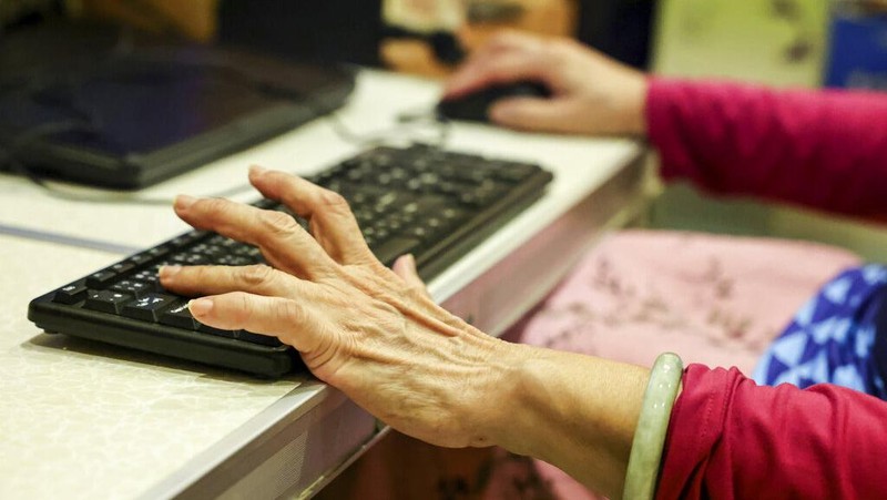 Chiang Yi-Shu watches the screen during the competition at Hungkuang University in Taichung, Taiwan on Saturday, Dec. 17, 2022.Chiang is one of the League of Legends players on Hungkung Evergreen Gaming's team, established this summer. The team, whose members range from 62 to 69 years old, was founded by Huang Jianji, the director of the department of Multimedia Game development and application of Hungkuang University. They competed in their first-ever video game tournament Saturday at the university. (AP photo/I-Hwa Cheng)