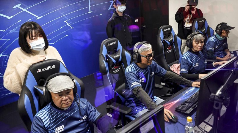 Chiang Yi-Shu watches the screen during the competition at Hungkuang University in Taichung, Taiwan on Saturday, Dec. 17, 2022.Chiang is one of the League of Legends players on Hungkung Evergreen Gaming's team, established this summer. The team, whose members range from 62 to 69 years old, was founded by Huang Jianji, the director of the department of Multimedia Game development and application of Hungkuang University. They competed in their first-ever video game tournament Saturday at the university. (AP photo/I-Hwa Cheng)