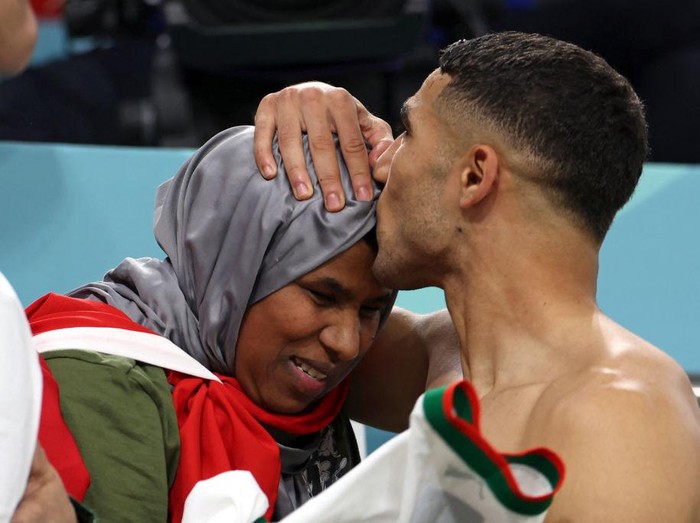 Morocco's defender #02 Achraf Hakimi (R) is greeted by his mother at the end of the Qatar 2022 World Cup Group F football match between Belgium and Morocco at the Al-Thumama Stadium in Doha on November 27, 2022. (Photo by Fadel Senna / AFP) (Photo by FADEL SENNA/AFP via Getty Images)