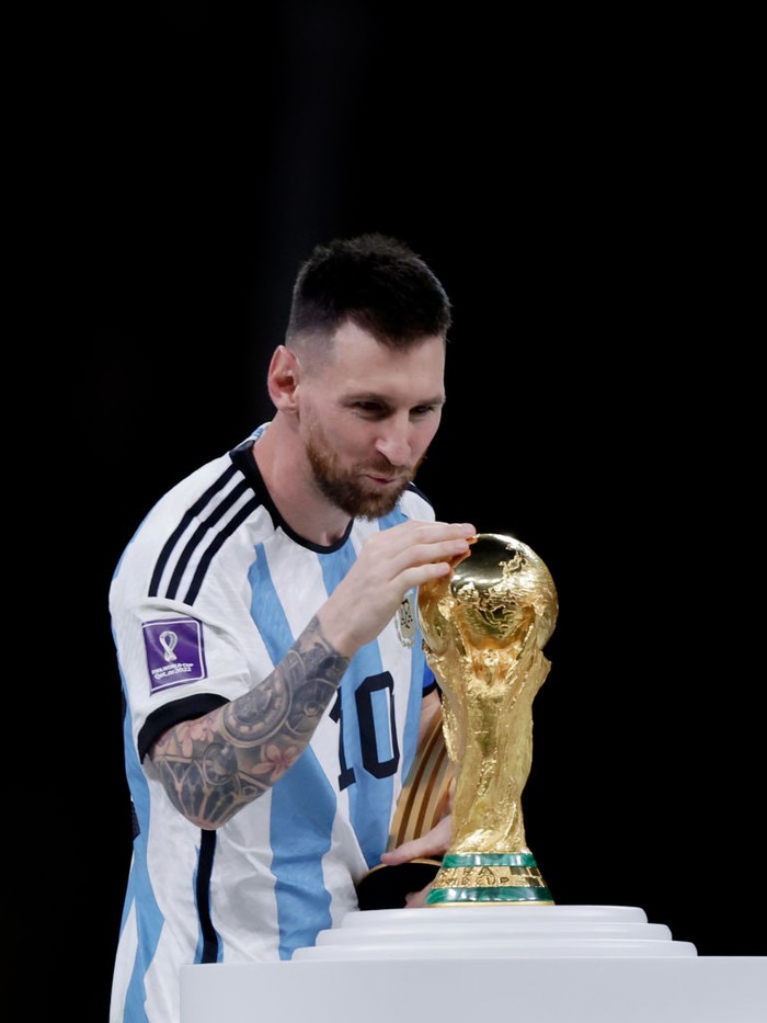 LUSAIL CITY, QATAR - DECEMBER 18: Lionel Messi of Argentina with the golden ball award for best player of the tournament celebrates with the World Cup trophy during the  World Cup match between Argentina  v France at the Lusail Stadium on December 18, 2022 in Lusail City Qatar (Photo by Eric Verhoeven/Soccrates/Getty Images)
