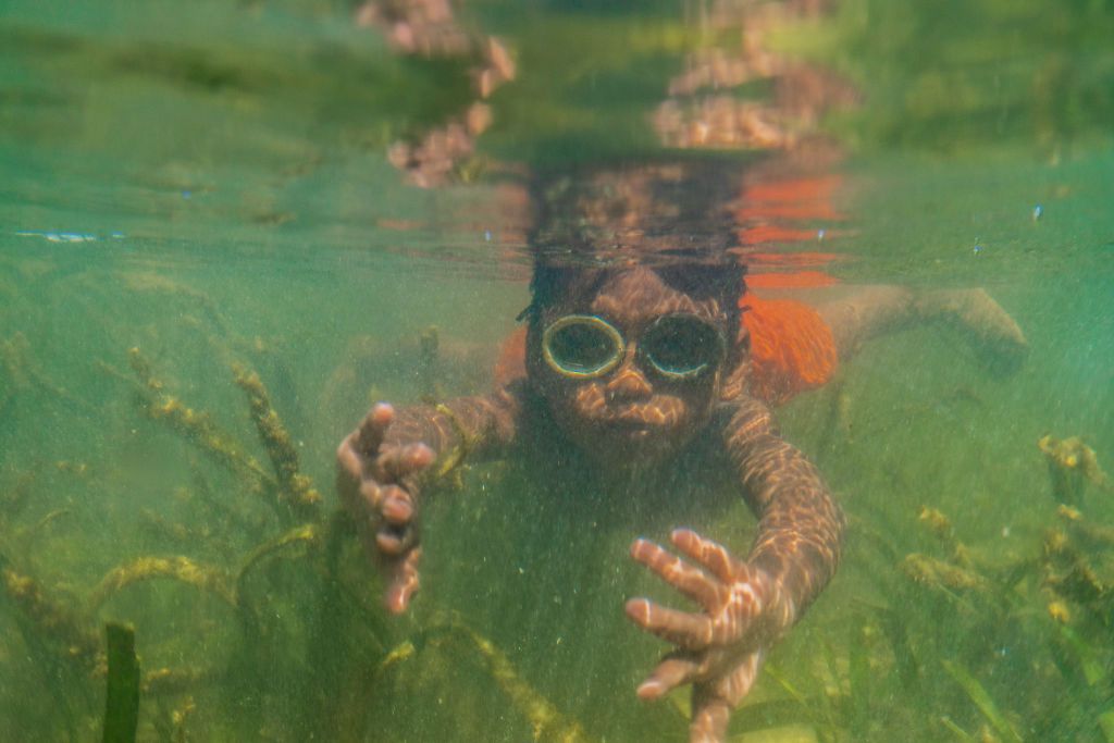 BUTON, SOUTH EAST SULAWESI, INDONESIA - 2020/10/02: Dimas Saputra (10 years old) seen diving in the sea. The life of the Bajo tribe, from birth to adulthood, is dependent on the sea. Everything is done there, from looking for food to all life activities carried out in the sea. Dimas Saputra is one of the many children who became an accomplished bajo child with extraordinary diving skills at a young age. (Photo by Andry Denisah/SOPA Images/LightRocket via Getty Images)