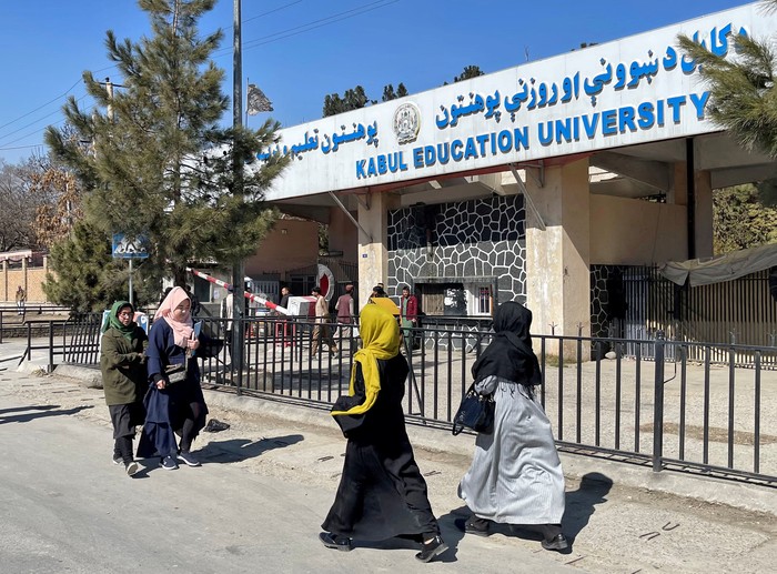Members of the Taliban stand guard at the entrance gate of Kabul University in Kabul, Afghanistan, December 21, 2022. REUTERS/Ali Khara