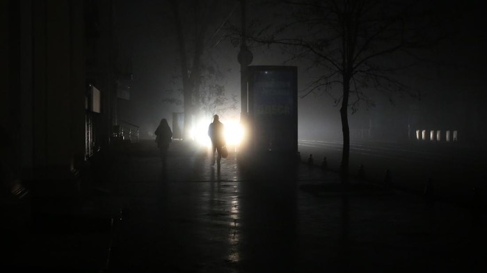 Passengers ride in a city bus down a street during a power cut in downtown Odessa, on December 5, 2022, amid the Russian invasion of Ukraine. - Ukraine was targeted on December 5, 2022 after nearly half of the country's energy grid has been destroyed by recent Russian missile strikes and Kyiv warning of a fresh wave of attacks. (Photo by OLEKSANDR GIMANOV / AFP) (Photo by OLEKSANDR GIMANOV/AFP via Getty Images)