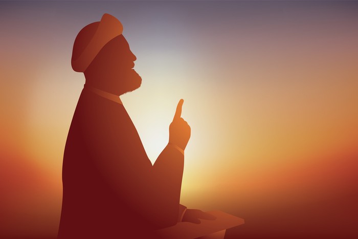 Symbol of the Shia Muslim religion with an Ayatollah who prays and preaches in front of his followers by stretching a finger upwards.