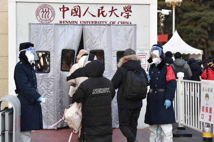 1245807167 YANTAI, CHINA - DECEMBER 24, 2022 - Candidates wait in line for the 2023 national postgraduate entrance exam at a test center in Yantai, East China's Shandong province, Dec. 24, 2022. (Photo credit should read CFOTO/Future Publishing via Getty Images)