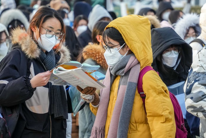 1245807167 YANTAI, CHINA - DECEMBER 24, 2022 - Candidates wait in line for the 2023 national postgraduate entrance exam at a test center in Yantai, East China's Shandong province, Dec. 24, 2022. (Photo credit should read CFOTO/Future Publishing via Getty Images)