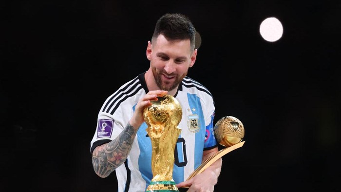 LUSAIL CITY, QATAR - DECEMBER 18: Lionel Messi of Argentina celebrates with the World Cup Trophy and player of the tournament award during the FIFA World Cup Qatar 2022 Final match between Argentina and France at Lusail Stadium on December 18, 2022 in Lusail City, Qatar. (Photo by Marc Atkins/Getty Images)