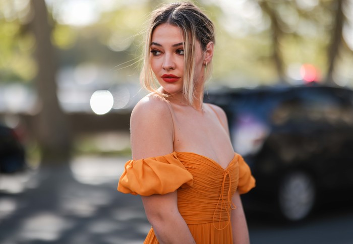 Madelyn Cline PARIS, FRANCE - OCTOBER 04: Madelyn Cline wearing orange dress outside Giambattista Valli Show on October 04, 2021 in Paris, France. (Photo by Jeremy Moeller/Getty Images)