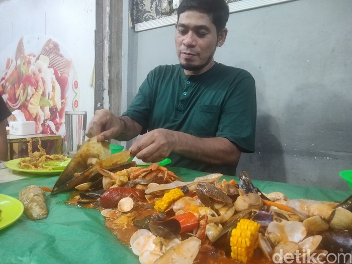 Menikmati hidangan seafood dengan belasan jenis olahan hewan laut. (Perdana Ramadhan / detikSumut)