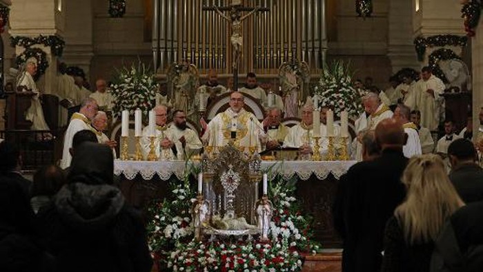 The acting Latin Patriarch of Jerusalem Pierbattista Pizzaballa leads a Christmas midnight mass at Saint Catherines Church, in the Church of the Nativity in Bethlehem, in the Israeli-occupied West Bank, on December 25, 2022. (Photo by AHMAD GHARABLI / POOL / AFP)