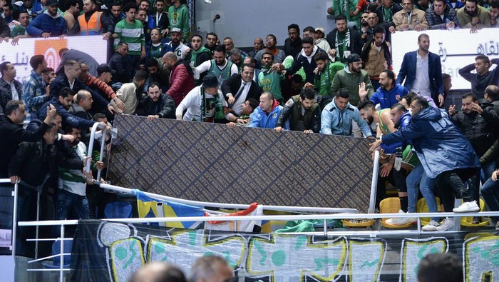GIZA, EGYPT - DECEMBER 25: A part of the tribune falls down during the Egypt Basketball Super Cup match between Al Ittihad Alexandria and Al Ahli, at Hassan Moustafa Sports Hall in Giza, Egypt on December 25, 2022. Fans tried to save the people who were under the destroyed part. Some of them were injured in the incident. (Photo by Stringer/Anadolu Agency via Getty Images)