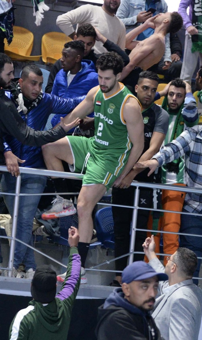 GIZA, EGYPT - DECEMBER 25: A part of the tribune falls down during the Egypt Basketball Super Cup match between Al Ittihad Alexandria and Al Ahli, at Hassan Moustafa Sports Hall in Giza, Egypt on December 25, 2022. Fans tried to save the people who were under the destroyed part. Some of them were injured in the incident. (Photo by Stringer/Anadolu Agency via Getty Images)