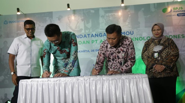 BPJS Ketenagakerjaan Gandeng Ayoconnect Layani PMI Direktur Pelayanan BPJS Ketenagakerjaan-Roswita Nilakurnia, Direktur Perencanaan Strategis dan TI BPJS Ketenagakerjaan-Pramudya Iriawan Buntoro dan Direktur Keuangan PT. Ayopop Teknologi Indonesia Alexander Andrew Jatra menandatangani Kesepahaman Bersama terkait Penjajakan Dan Peninjauan Potensi Kerjasama melalui Pemanfaatan Teknologi Digital yang disaksikan oleh Direktur Utama BPJS Ketenagakerjaan-Anggoro Eko Cahyo di Jakarta, Senin (26/12/2022). MoU ini bertujuan untuk memberikan kemudahan bagi para peserta BPJS Ketenagakerjaan khususnya segmen Pekerja Migran Indonesia (PMI) dalam melakukan pendaftaran, pembayaran iuran, dan klaim manfaat di negara penempatan.