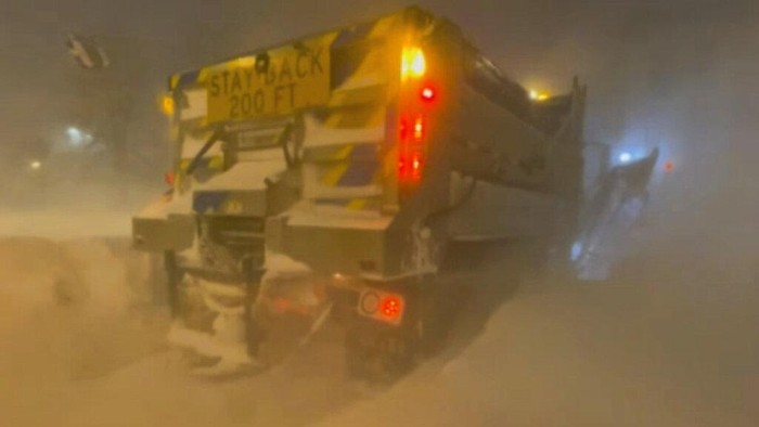 High winds and snow covers the streets and vehicles in Buffalo, N.Y. early Sunday, Dec. 25, 2022. Millions of people hunkered down in a deep freeze overnight and early morning to ride out the frigid storm that has killed at least 20 people across the United States, trapping some residents inside homes with heaping snow drifts and knocking out power to several hundred thousand homes and businesses. (WKBW via AP)
