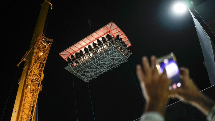 People dine in the air at the Altum restaurant in Caracas, Venezuela, late Thursday, Dec. 22, 2022. Altum, the 