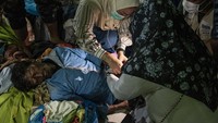 Petugas tampak memasang selang infus kepada seorang imigran Rohingya.