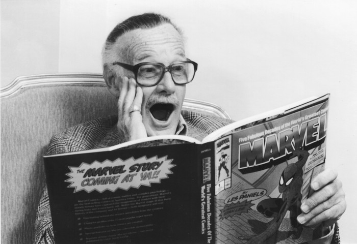 1066674784 New York, N.Y.: Comic book creator Stan Lee smiles while reading a book celebrating 50 years of Marvel Comics at Helmsley Palace Hotel in New York, New York on October 14, 1991. (Photo by David Pokress/Newsday RM via Getty Images)