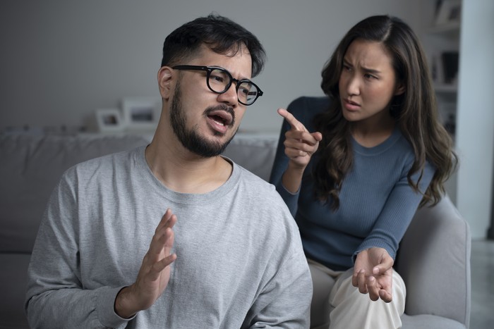 Asian couple arguing shouting blaming each other of problem, husband and wife fighting at home, relationship Problems concept