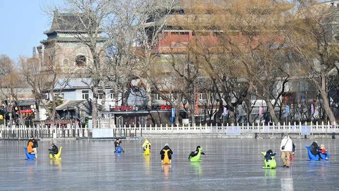 BEIJING, CHINA - DECEMBER 27: People enjoy ice-skating on the frozen Shicha Lake on December 27, 2022 in Beijing, China. (Photo by VCG/VCG via Getty Images)