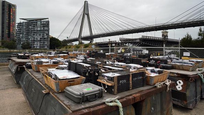 SYDNEY, AUSTRALIA - DECEMBER 29: Worker is seen as fireworks are loaded on to barges during a media call ahead of Sydney New Year's Eve 2022/23 celebrations, on Glebe Island in Sydney, Australia, on Thursday, December 29, 2022. More than 35,000 shooting ground-based effects, 12,000 aerial shells and over 100,000 individual pyrotechnic effects will be launched from four building rooftops across the city as well as barges, the Sydney Harbour Bridge and the Sydney Opera House sails on New Year's Eve in Sydney. (Photo by Stringer/Anadolu Agency via Getty Images)