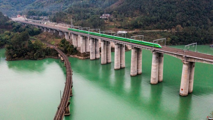 LESHAN, CHINA - DECEMBER 26: The first Fuxing high-speed train runs along the new Chengdu-Kunming High-speed Railway on December 26, 2022 in Leshan, Sichuan Province of China. With a length of 915 km and a designed speed of 160 km per hour, a new high-speed railway linking Chengdu and Kunming fully opened on Monday, cutting the travel time from 19 hours to 7.5 hours. (Photo by VCG/VCG via Getty Images)