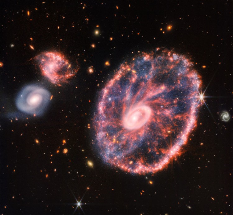 This image is dominated by NGC 7469, a luminous, face-on spiral galaxy approximately 90 000 light-years in diameter that lies roughly 220 million light-years from Earth in the constellation Pegasus. Its companion galaxy IC 5283 is partly visible in the lower left portion of this image. This spiral galaxy has recently been studied as part of the Great Observatories All-sky LIRGs Survey (GOALS) Early Release Science program with the NASA/ESA/CSA James Webb Space Telescope, which aims to study the physics of star formation, black hole growth, and feedback in four nearby, merging luminous infrared galaxies. Other galaxies studied as part of the survey include previous ESA/Webb Pictures of the Month II ZW 096 and IC 1623. NGC 7469 is home to an active galactic nucleus (AGN), which is an extremely bright central region that is dominated by the light emitted by dust and gas as it falls into the galaxys central black hole. This galaxy provides astronomers with the unique opportunity to study the relationship between AGNs and starburst activity because this particular object hosts an AGN that is surrounded by a starburst ring at a distance of a mere 1500 light-years. While NGC 7469 is one of the best studied AGNs in the sky, the compact nature of this system and the presence of a great deal of dust have made it difficult for scientists to achieve both the resolution and sensitivity needed to study this relationship in the infrared. Now, with Webb, astronomers can explore the galaxys starburst ring, the central AGN, and the gas and dust in between. Using Webbs MIRI, NIRCam and NIRspec instruments to obtain images and spectra of NGC 7469 in unprecedented detail, the GOALS team has uncovered a number of details about the object. This includes very young star-forming clusters never seen before, as well as pockets of very warm, turbulent molecular gas, and direct evidence for the destruction of small dust grains within a few hundred light-years of the nucleus  proving