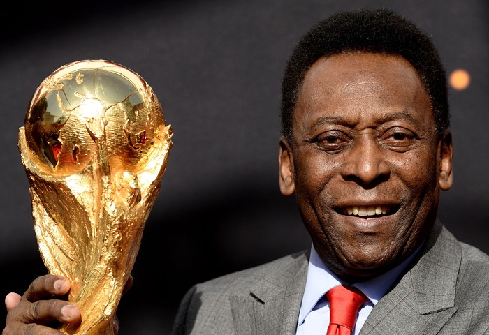 Brazilian football legend Pele poses with the FIFA World Cup trophy during a press conference, on March 9, 2014 outside the Hotel de Ville in Paris. The FIFA World Cup trophy arrived with its ambassador Pele in Paris on March 9, 2014 and will be exhibited on the Hotel de Ville plaza until March 10. AFP PHOTO / FRANCK FIFE (Photo by Franck FIFE / AFP) (Photo by FRANCK FIFE/AFP via Getty Images)