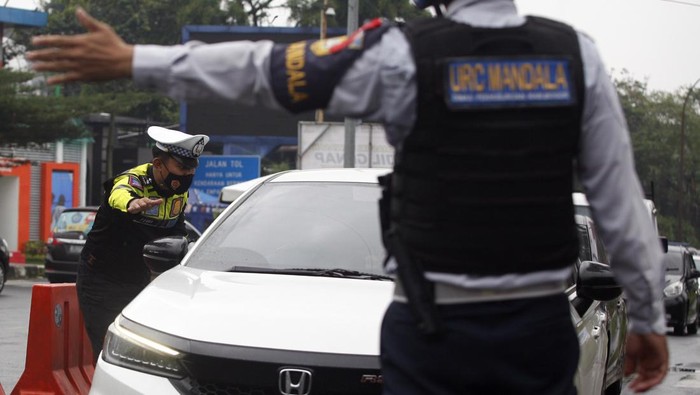 Jalur Wisata Puncak Bakal Ditutup Total Saat Malam Tahun Baru 2023 Petugas Sat Lantas Polres Bogor dan petugas Dishub Kabupaten Bogor mengarahkan kendaraan wisatawan saat penyekatan kendaraan nomor polisi ganjil genap di jalur wisata Puncak, Gadog, Kabupaten Bogor, Jawa Barat, Jumat (30/12/2022). Polres Bogor berencana menutup total jalur wisata Puncak guna meminimalisir pergerakan orang pada malam pergantian Tahun Baru 2023 mulai tanggal (31/12/2022) pukul 18.00 WIB hingga tanggal (1/1/2023) pukul 06.00 WIB . ANTARA FOTO/Yulius Satria Wijaya/rwa.