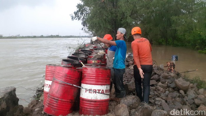 Petugas mengerjakan tanggul darurat di kawasan Pantai Marina Semarang, Jumat (30/12/2022).