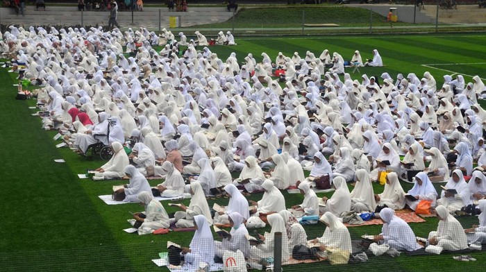Sejumlah warga memanjatkan doa usai membaca Al Quran secara bersama-sama di lapangan Sepak Bola Mini, Taman Manunggal, Kota Bogor, Jawa Barat, Sabtu (31/12/2022). Sebanyak seribu warga melakukan khataman Al Quran sebagai bentuk rasa syukur kepada Allah SWT menjelang Tahun Baru 2023 sekaligus sebagai bentuk syiar untuk selalu membaca Al Quran kepada umat Islam. ANTARA FOTO/Arif Firmansyah/nym.