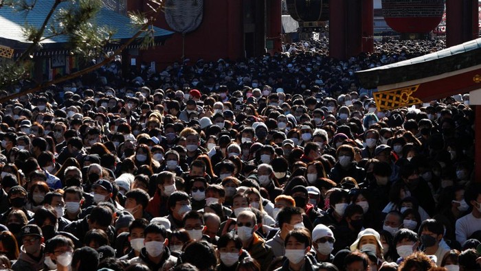 People leave after offering prayers on the first day of the new year at Senso-ji temple in Tokyo, Japan, January 1, 2023. REUTERS/Androniki Christodoulou