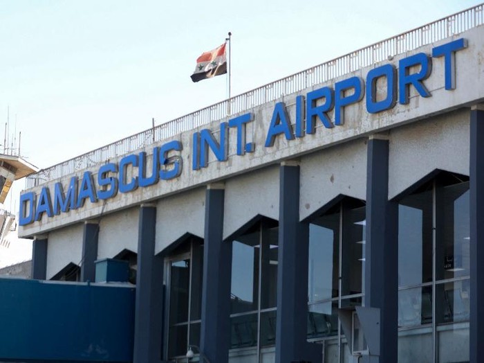 A picture shows the Syrian flag swaying in the wind at the Damascus International Airport on the outskirts of Syrias capital on October 1, 2020. (Photo by LOUAI BESHARA / AFP)