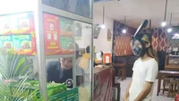 Takut terpapar virus, pria ini pakai peralatan utuk snorkeling untuk menutupi area wajahnya saat menunggu pesanannya jadi di warung makan. Foto: Instagram/Twitter