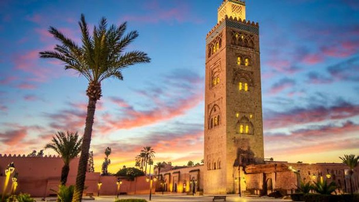 Koutoubia mosque in the morning surrounded by palm tree, Marrakesh, Morocco