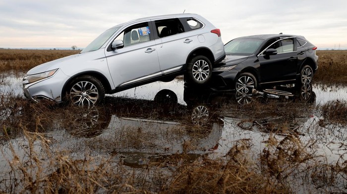 Mobil-mobil di California Saling Tumpuk Terseret Badai Cars are piled up next to a wheelchair submerged in the water after rainstorms caused flooding in Sacramento County, in Wilton, California, U.S. January 2, 2023. REUTERS/Fred Greaves