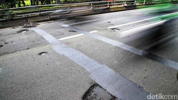 Pengendara diimbau waspada terhadap banyaknya lubang di jembatan layang Pancoran, Jakarta, Selasa (03/01/2023). Jalan berlubang ini bisa menyebabkan masyarakat celaka.