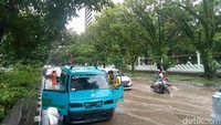 Genangan di depan Kantor Gubernur Sulsel membuat sejumlah kendaraan kesulitan melintas. (Foto: Ibrahim Rewa/detikSulsel)