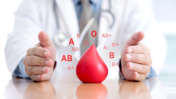 Gambar ilustratif tangan seorang dokter memegang tabung sampel darah dengan label yang menunjukkan berbagai golongan darah, digunakan untuk menentukan jenis darah pasien dalam konteks medis