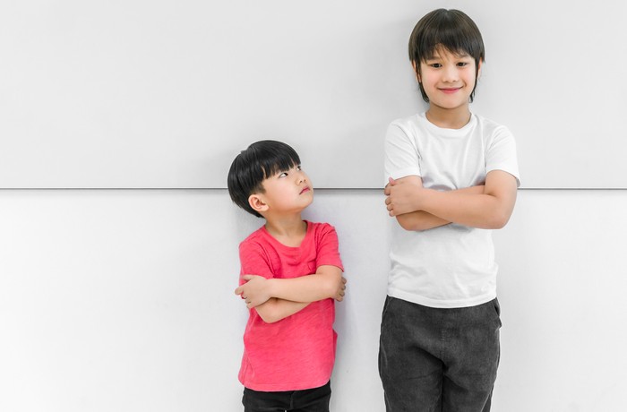 mother measuring height of her son