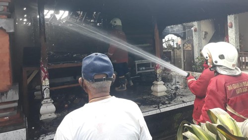 Personel Damkar Badung memadamkan api di bale adat milik warga di Banjar Umacandi, Desa Buduk, Kecamatan Mengwi, Badung, Rabu (4/1/2023). (Agus Eka)